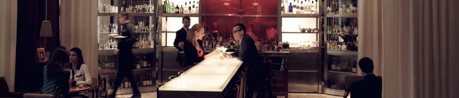 A bartender in conversation with a guest