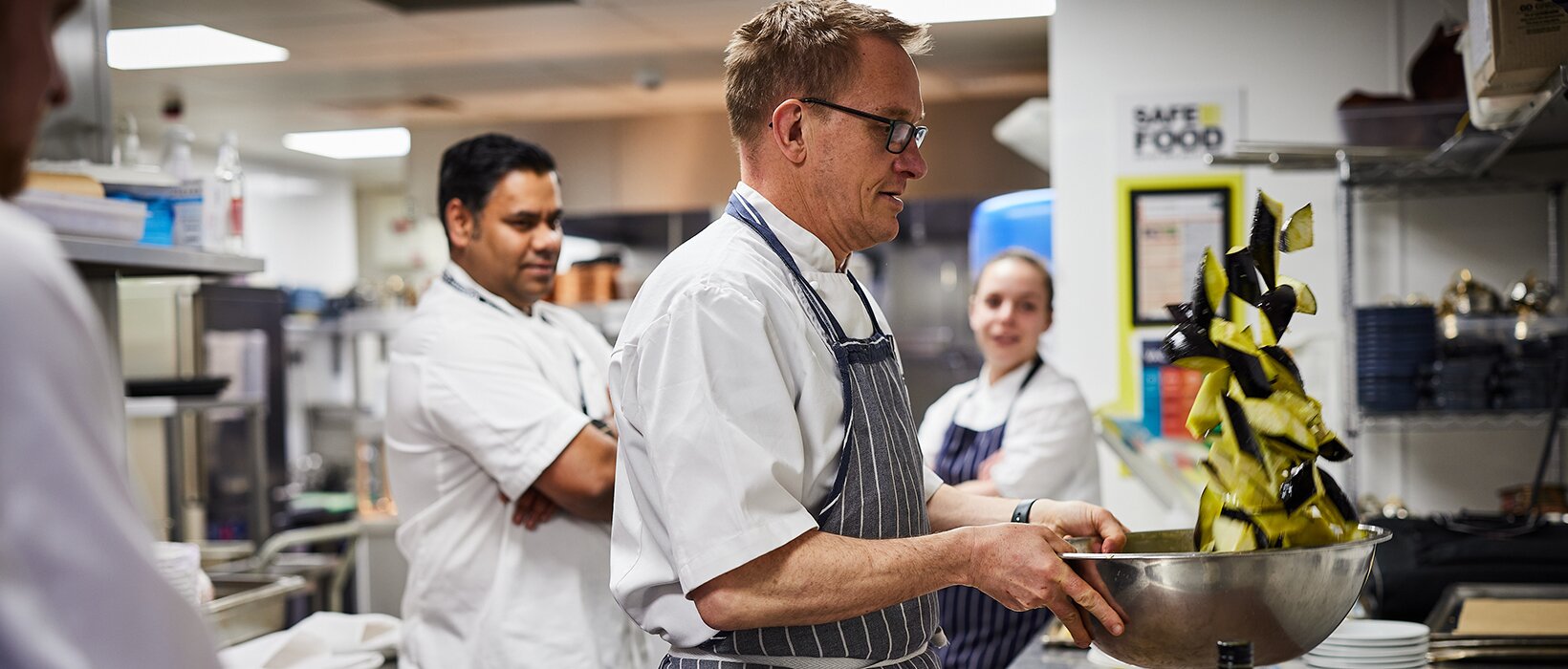 A facilities-management catering team preparing to a safety standard